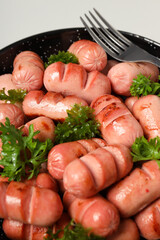 Concept of tasty food, grilled mini sausage, close up