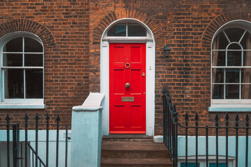 Vintage red door with brick wall. - Powered by Adobe
