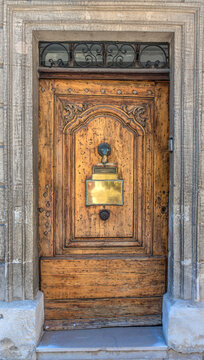 Old vintage wooden door with gilded metal plate