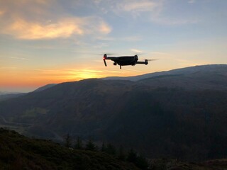 Fototapeta na wymiar Drone flying over the mountain at sunset.