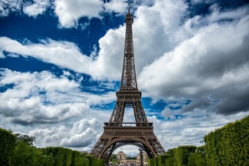 Beautiful view of the Eiffel Tower against a blue cloudy sky in Paris, France