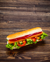 Hot dog with ketchup on wooden table 