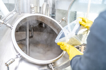 dried granulated hops in the brewery when brewing beer. added to a stainless steel tank when...