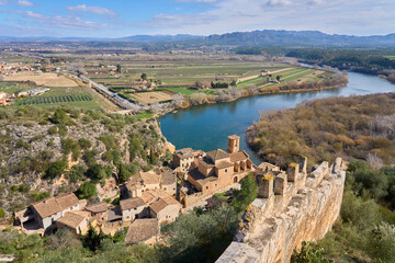 Fototapeta na wymiar Village and knights templar castle of Miravet at the banks of river Ebro in Catalonia, Spain