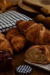 Tuinposter Closeup of tasty croissants baked in a cooker and served with raspberry jam © George Fallon/Wirestock Creators