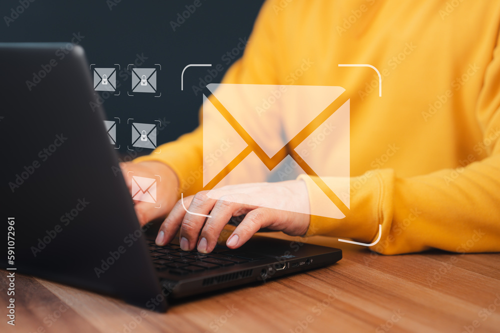 Poster Concept of Email marketing, send e-mail or news letter, online working internet network. Man hand using computer laptop typing on keyboard and surfing the internet on office table with email icon.
