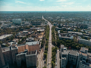 Aerial high view on street near Karazin National University and Derzhprom with cars driving to Freedom Square in warm spring Kharkiv, Ukraine