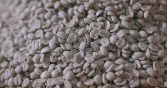 Closeup of a heap of unroasted coffee beans.