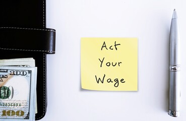 Notebook pen money with handwritten stick note ACT YOUR WAGE, viral  workplace trend which...