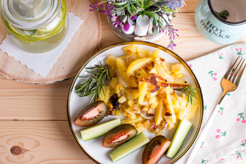 green tea with lime and mint in a glass jar with a plate of country fried potatoes. Homemade food, lunch
