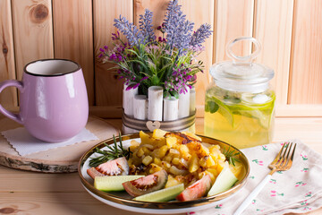 green tea with lime and mint in a glass jar with a plate of country fried potatoes. Homemade food, lunch