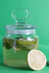 green drink with lime and mint in a glass jar. Non-alcoholic mojito, soft drink