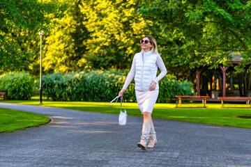 Beautiful woman walking in city park
