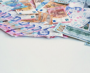 Money pile. World economy. Global market. Closeup of colorful Euro US American dollar Ukrainian UAH hryvnia bill paper banknotes cash on white empty space background.