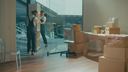 Workers of Moving Company With Uniforms Carefully Carrying Furniture. Team of Employee Workers Helps Customers to Relocation. Local Moving Services