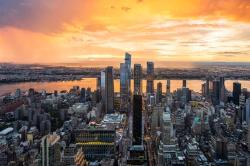 Fototapeten A beautiful colourful sunset during rainy storm over the Hudson Yards in New York City. © Ondrej Bucek