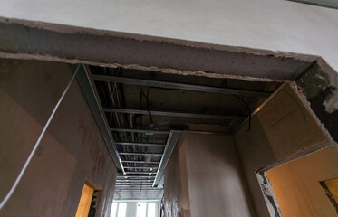 Ceiling installation with expert technicians In the room that is in the construction process.