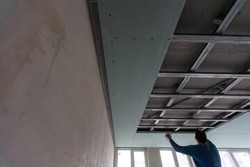 Construction worker, making walls from gypsum plasterboard or drywall