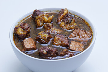 Rawon, Indonesian beef black soup. Originating from Surabaya, East Java. utilizes the black nut Keluak as the main seasoning, which gives a dark color to the soup. isolated white background