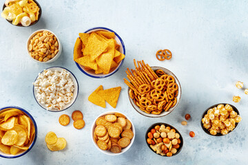 Salty snacks, party mix, overhead flat lay shot. An assortment of appetizers. Potato and tortilla...