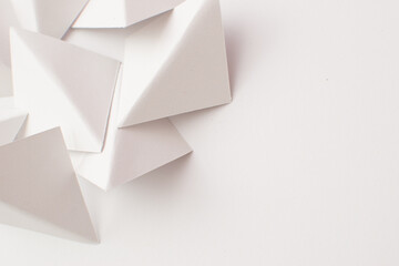 Close up of white 3d geometric shapes on white background with copy space