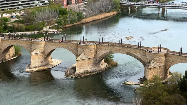 The Ebro river and the old Stone Bridge in Zaragoza in Spain. High quality 4k footage.