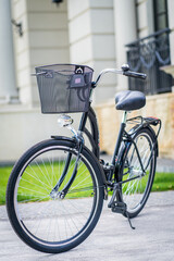 Metal bicycle basket. Vintage bike on the street as background.