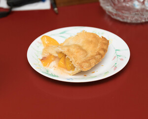 the first piece of a delicious peach pie