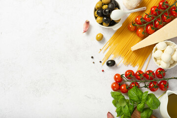 Ingredients of mediterranean cuisine in the form of the Italian flag on a white slate,stone or concrete background.