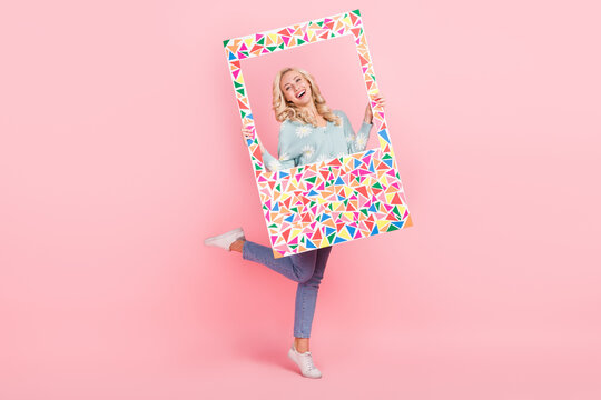 Full length photo of cheerful cute girl wear flower print cardigan taking photo colorful frame isolated pink color background