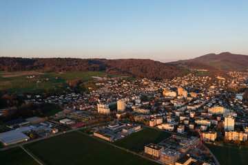 Sunset during the golden hour in a neighborhood above the rooftops of a small town in Switzerland.