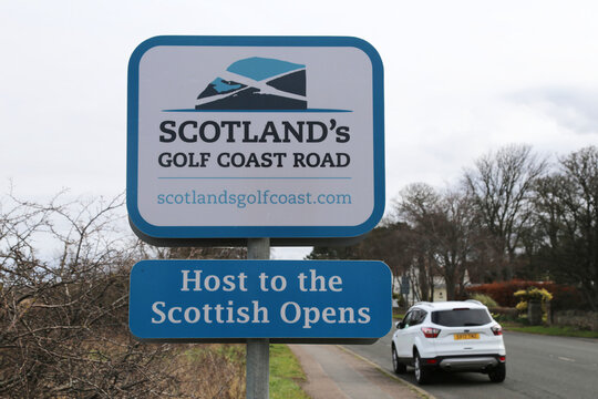 A closeup view of a reflective sign advertising the nearby golf courses in East Lothian, Scotland, UK.
