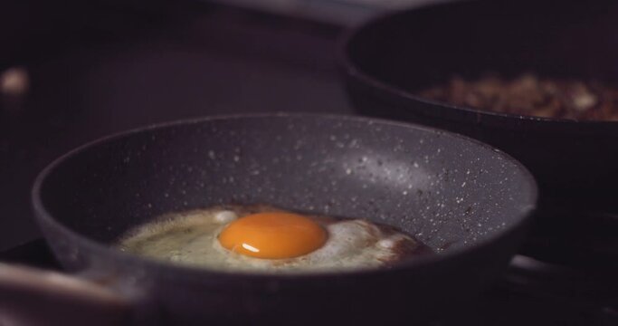 Slow motion of frying eggs in a hot pan