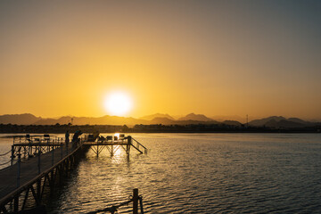 Naklejka na ściany i meble Sunset over the Red Sea and the mountains of Sharm El Sheikh.
