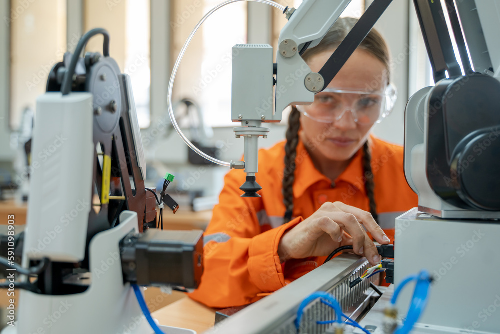 Leinwandbilder engineer examining robotic arm in industry,modern equipment and new era in computer science and robo