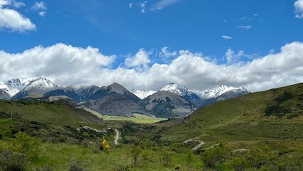 Fototapeta premium Scenic view of a mountainous green landscape in New Zealand on a bright summer day
