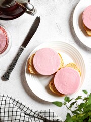 Vertical top view of a plate with bread slices and sausage slices