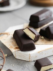 Vertical closeup shot of gourmet chocolate marzipan bars on a wooden board