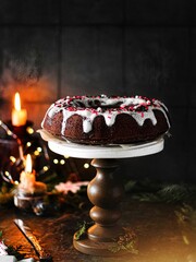 Vertical shot of a decorative stand with a gourmet Christmas cake