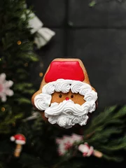 Fotobehang Vertical closeup shot of a beautiful frosted Santa Christmas cookie © Masha Svejenceva/Wirestock Creators