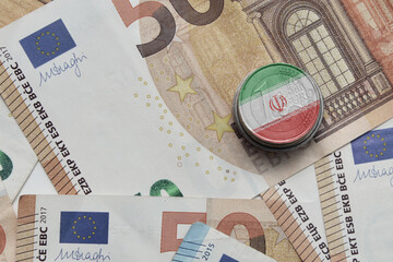 euro coin with national flag of iran on the euro money banknotes background