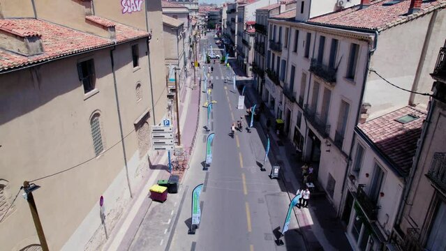 Aerial tracking shot of a couple cycling through the Les dimanches de Respiration course