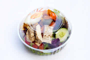 Salad with meat and vegetables in plastic package box