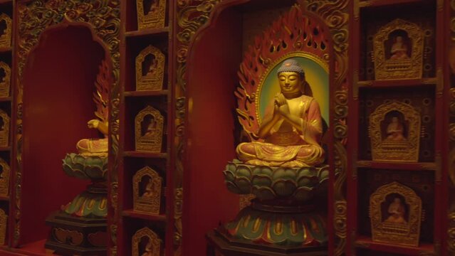 Wall of Gautama Buddha at Tooth Relic Temple main statue sculpture rabbit year chinese new year Chinatown Singapore red flames differents mudra