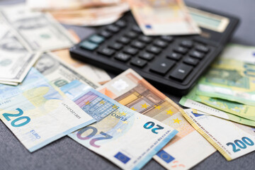 Euro and dollar notes. euro against dollar. A closer look of the president of the USA with a dollar bill, peeping out from behind a euro bill. USA and Europe finance relation. Close up top view.