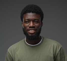 Studio shot of isolated on grey background black man dressed in casual attire.