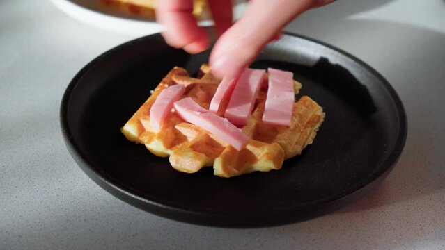 Waffle pizza with ham and pickled cucumbers and cheese. Hybrid food, piffle