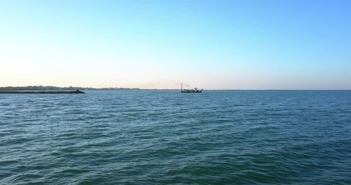 Sand dredging ship on the shore of the beach
