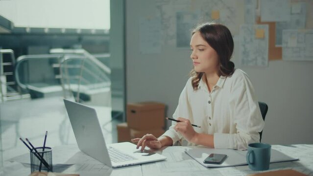 A Female Architect in Her Modern Office Creates Innovative Designs Using Advanced Technologies and Tools. She Works On Blueprints, Sketches and Technical Equipment to Bring Her Creative Vision to Life
