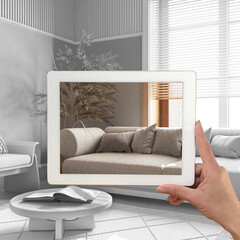 Augmented reality concept. Hand holding tablet with AR application used to simulate furniture products in custom architecture design, total white background, japandi living room